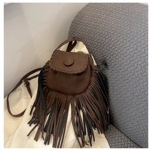 Detailed macro view of the brown suede fringe crossbody bag with soft bohemian tassels