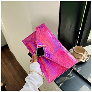 Detail of holographic pink crocodile pattern envelope clutch bag with gold geometric buckle