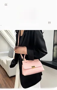 Detail of pink lychee pattern texture on a trapezoid handbag with gold metal clasp closure