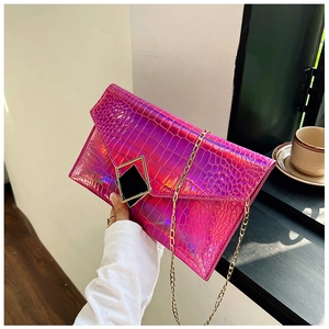 Close-up of holographic purple crocodile texture bag with gold chain and geometric clasp