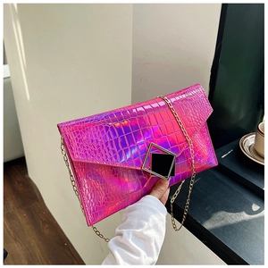 Macro detail of fuchsia crocodile-embossed iridescent laser envelope bag with metal buckle