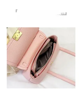 Detailed view of the pink lychee leather crossbody bag interior with large storage sections