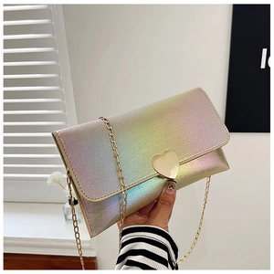 Detail of glitter gradient chain bag with golden heart-shaped metal buckle and flip cover