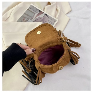Detailed view of brown suede crossbody bag with purple lining and tassel accents