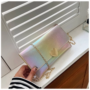 Detail of laser iridescent gradient envelope purse with gold heart buckle and chain strap