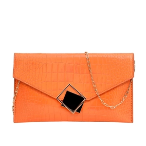 Orange faux crocodile skin envelope clutch bag with gold chain and square buckle detail