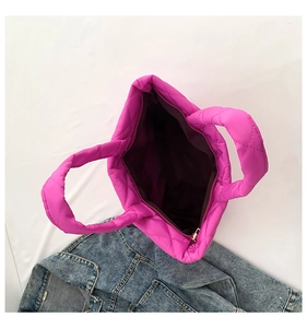 Top view of fuchsia quilted tote bag featuring a spacious interior and zipper closure