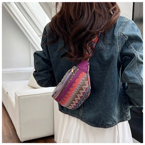 Close-up of bohemian embroidered waist bag with vintage geometric weaving and purple trim