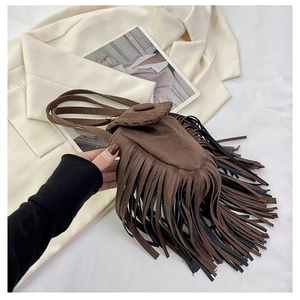 Close-up of deep brown faux suede saddle bag with fringe details and contrast stitching