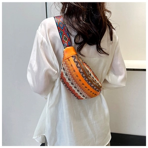 Detailed view of bohemian crossbody bag with colorful jacquard fabric and orange leather