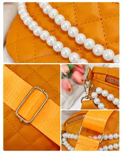 Détail du sac orange matelassé avec chaîne en perles et fermoirs en métal doré