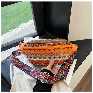 Close-up of bohemian woven waist bag with colorful geometric patterns and adjustable strap