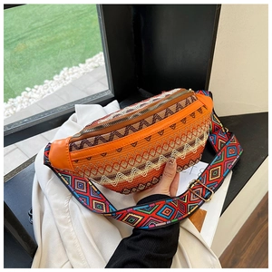 Detail of adjustable bohemian strap and orange geometric woven pattern on the waist bag
