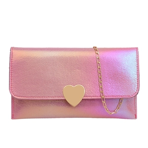 Iridescent pink clutch bag with large gold heart clasp and chain strap in front view