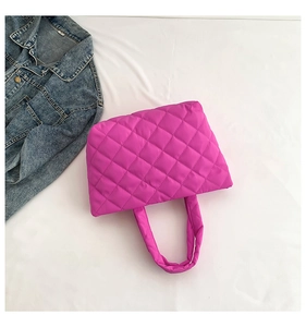 Detail of hot pink quilted puffer tote bag with spacious interior and wide padded handles