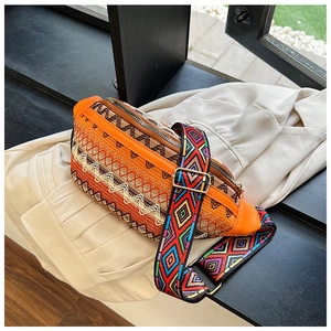 Detailed view of ethnic woven crossbody bag with colorful geometric patterns and wide strap