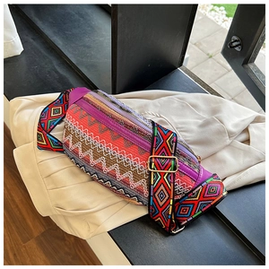 Detail of bohemian waist bag showing vibrant woven patterns and purple leather accents
