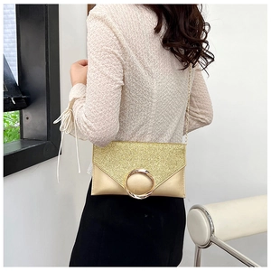 Detail of champagne gold sequin envelope clutch bag with metal ring and chain strap