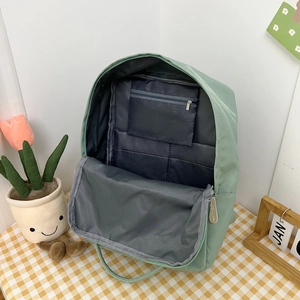 Detail view of the spacious inner lining with zipper pocket and dual open compartments