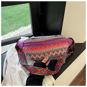 Close-up of bohemian ethnic woven waist bag with purple trim and adjustable geometric strap