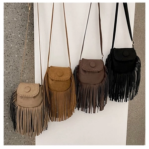 Hanging display of suede tassel saddle bags in beige, caramel, coffee, and black