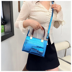Detail of blue stone pattern handbag with glossy finish and brown resin handle