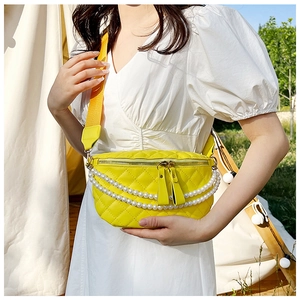 Détail du sac banane matelassé jaune avec chaînes en perles et double fermeture éclair