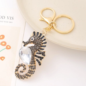 Seahorse keychain with black rhinestones and large heart crystal on gold metal base