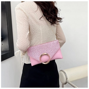 Pink sequin envelope clutch bag with gold ring buckle shown on model with chain strap