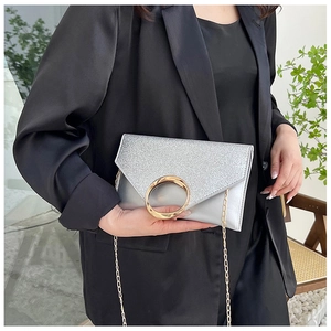 Silver sequin envelope clutch bag with gold ring handle and metal chain detail