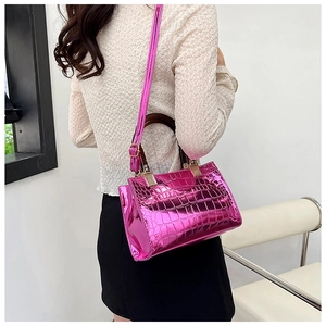 Detail of glossy pink faux crocodile leather texture and metallic shine on a tote bag