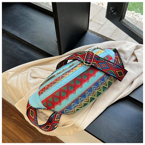 Detailed view of bohemian ethnic embroidered waist bag with colorful geometric patterns