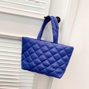Royal blue quilted tote bag with puffer design and spacious interior for women