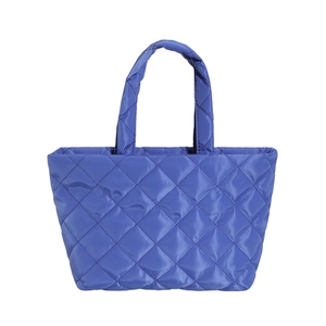 Bright blue quilted puffer tote bag with diamond stitching and soft padded top handles