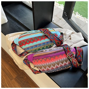 Close-up of ethnic style embroidered waist bags with intricate geometric woven patterns
