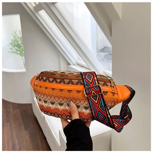 Detail of the woven ethnic waist bag with textured waves and colorful geometric strap