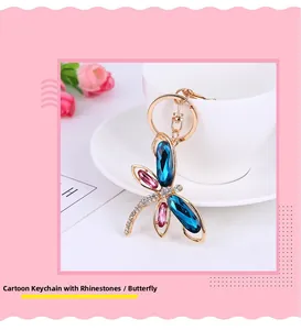 Detail of dragonfly keychain with blue and pink crystals on gold metal hook