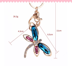 Detailed view of dragonfly keychain dimensions showing size measurements and crystal accents