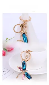 Detail view of gold butterfly keychain with blue crystals and sparkling rhinestones