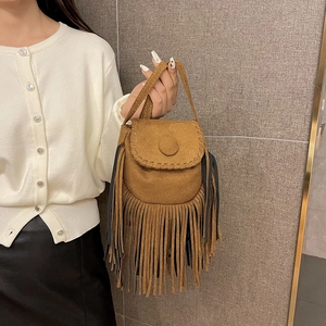 Vintage bohemian camel suede crossbody bag with decorative tassels and a stitch design