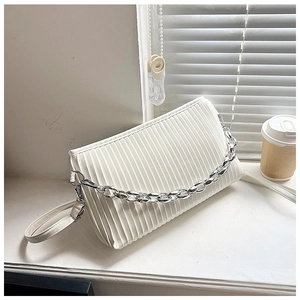 Close-up of white pleated PU handbag featuring a chunky silver chain and slim shoulder strap