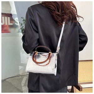 On-body view of silver metallic tote bag with faux croc skin texture and resin handle