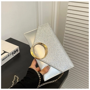 Detail of silver sequin envelope clutch with gold metal buckle and delicate chain strap