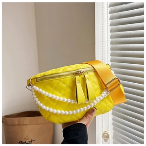 Détail du sac bandoulière jaune matelassé avec chaînes de perles et large bandoulière