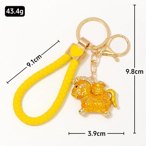Chinese style golden pony keychain with yellow braided rope and heart metal charm