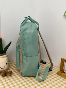 Side view of large capacity backpack in mint green and khaki with side storage pocket