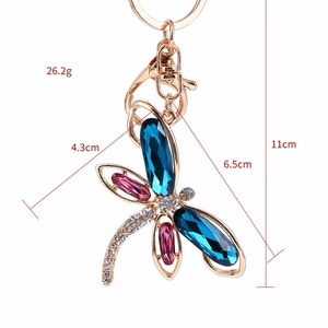 Sparkling dragonfly keychain with blue and pink crystals on a golden alloy base