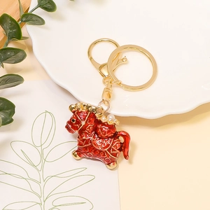 Detailed close-up of a red Chinese zodiac horse keychain with gold accents and pearls