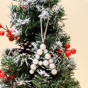 Macro shot of pearl letter A Christmas tree ornament with silver setting and grey string
