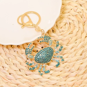 Exquisite gold-plated crab keychain featuring sparkling blue rhinestones for holiday gifting